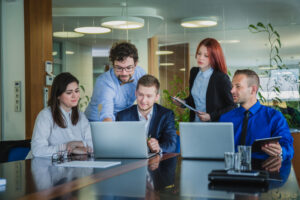 A group of professionals collaborating in a Canadian office environment, representing skilled workers eligible for the Canadian Experience Class.