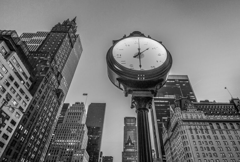 low-angle-view-clock-against-tall-buildings