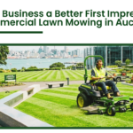 Commercial lawn mowing service in Auckland maintaining a large business landscape with professional equipment and neatly trimmed grass
