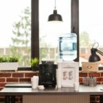 close-up-water-dispenser-coffee-machine-table-meeting-office-liquid-refreshment-people-working-modern-workplace-fresh-beverage-equipment-hydrate-break_482257-27404