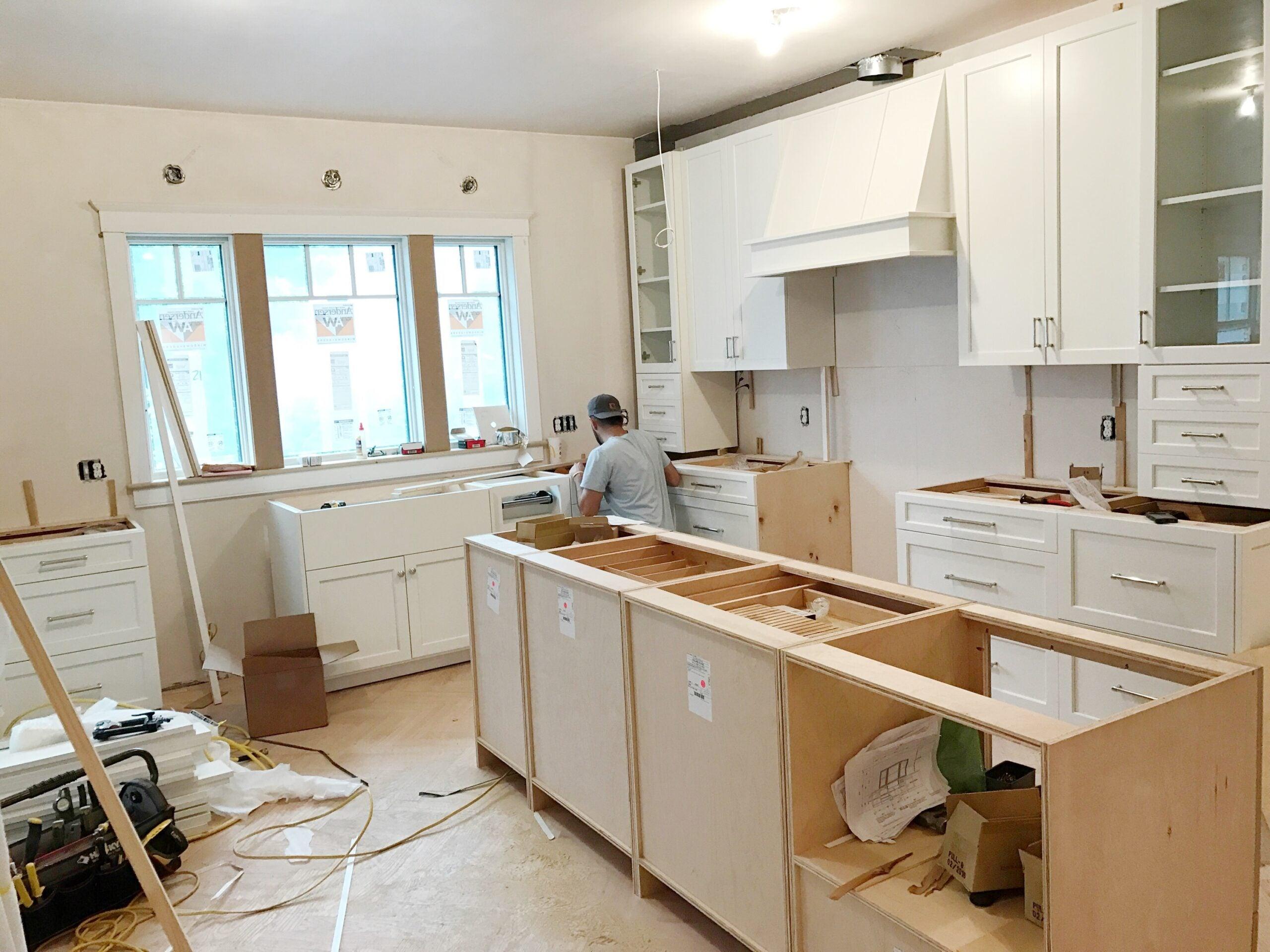 Homeowner planning a kitchen remodel with professional contractor guidance