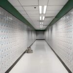 "Business owner storing important documents securely in a safe deposit box vault"
