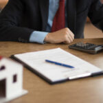 real estate agent calculates sales data