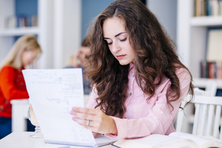 student-reading-notes-library